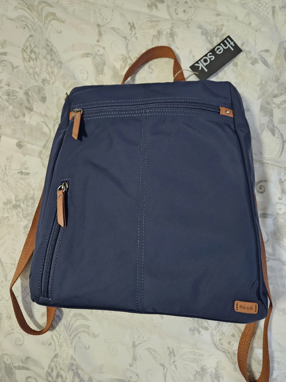 The Sak Navy Backpack with Brown Trim and Straps